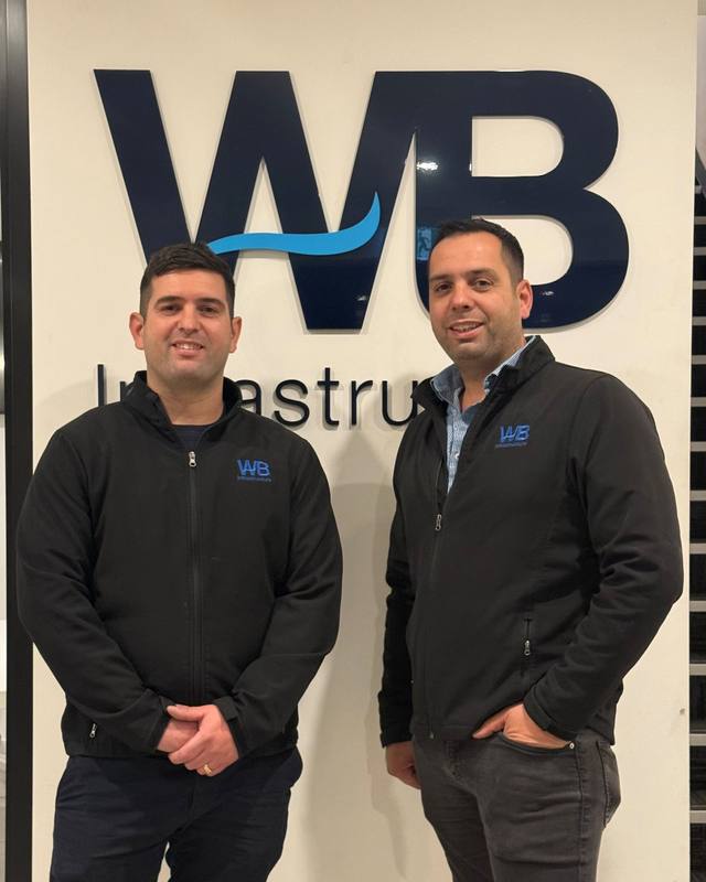 Bill and Nick, directors of WB Infrastructure, in front of the WB sign.