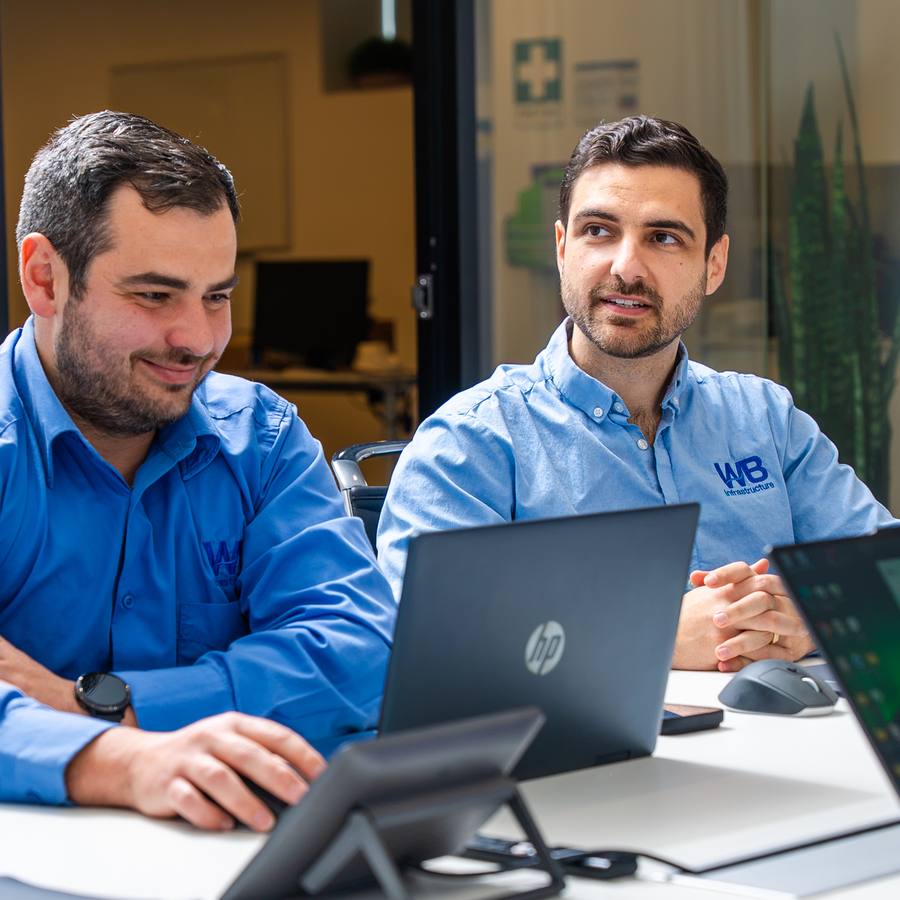 Two of the WB team at their desks.