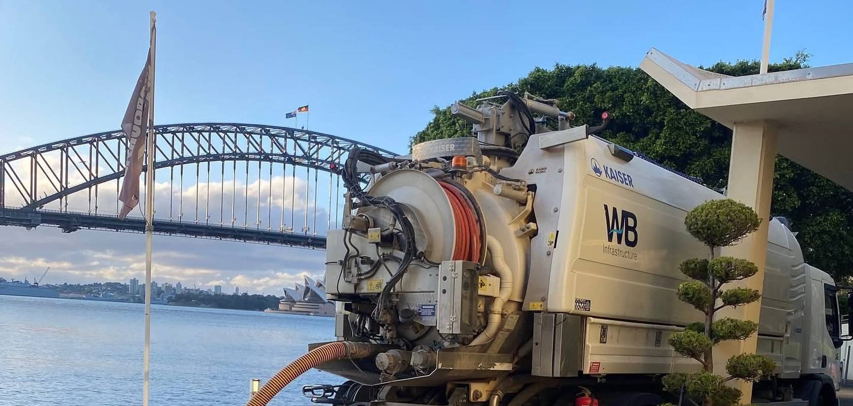 A WB combination truck clearing a blockage on the shore of Sydney Harbour.