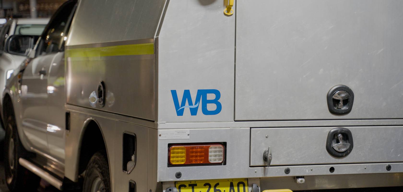 A WB-branded service ute at night.