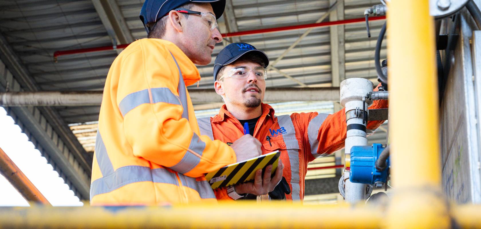 WB technicians inspecting equipment at a facility.